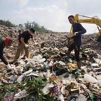 Männer arbeiten auf einer Mülldeponie